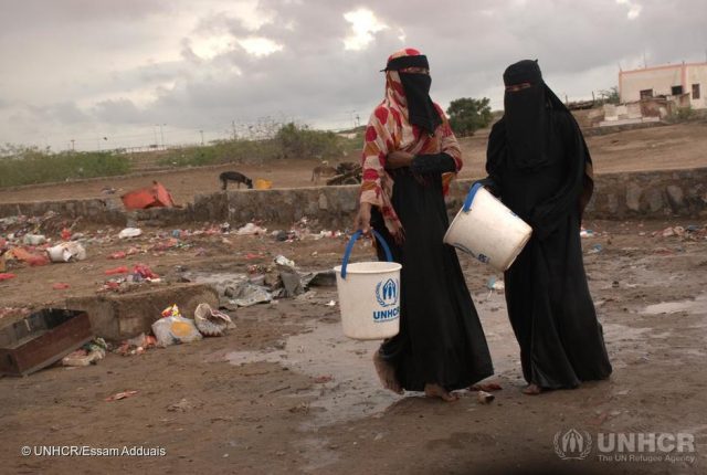 Yemen. Heavy rain and floods affect displaced families in Aden Two women pour out water from their shelter at a hosting site for internally displaced persons in Aden, after rain caused extensive damage on 25 March 2020. ; A rapid assessment of sites was carried out to evaluate damage, needs and priorities. UNHCR-led Camp Coordination and Camp Management Cluster (CCCM) and Shelter teams visited four sites hosting close to 600 families – Ammar Bin Yasser and the Agricultural Saudi Institute in Dar Sa’ad, Al Sawama’a in Al-Mualla and Hosh Al-zira’ah in Khor-Makser. Monitoring showed that about 400 families (2,800 people) have been severely affected – their shelters damaged, food rations lost and core relief items, including mattresses, destroyed. UNHCR is coordinating the response with partners. Since conflict began in 2015, tens of thousands of people have been killed or injured and 3.65 million displaced in Yemen.